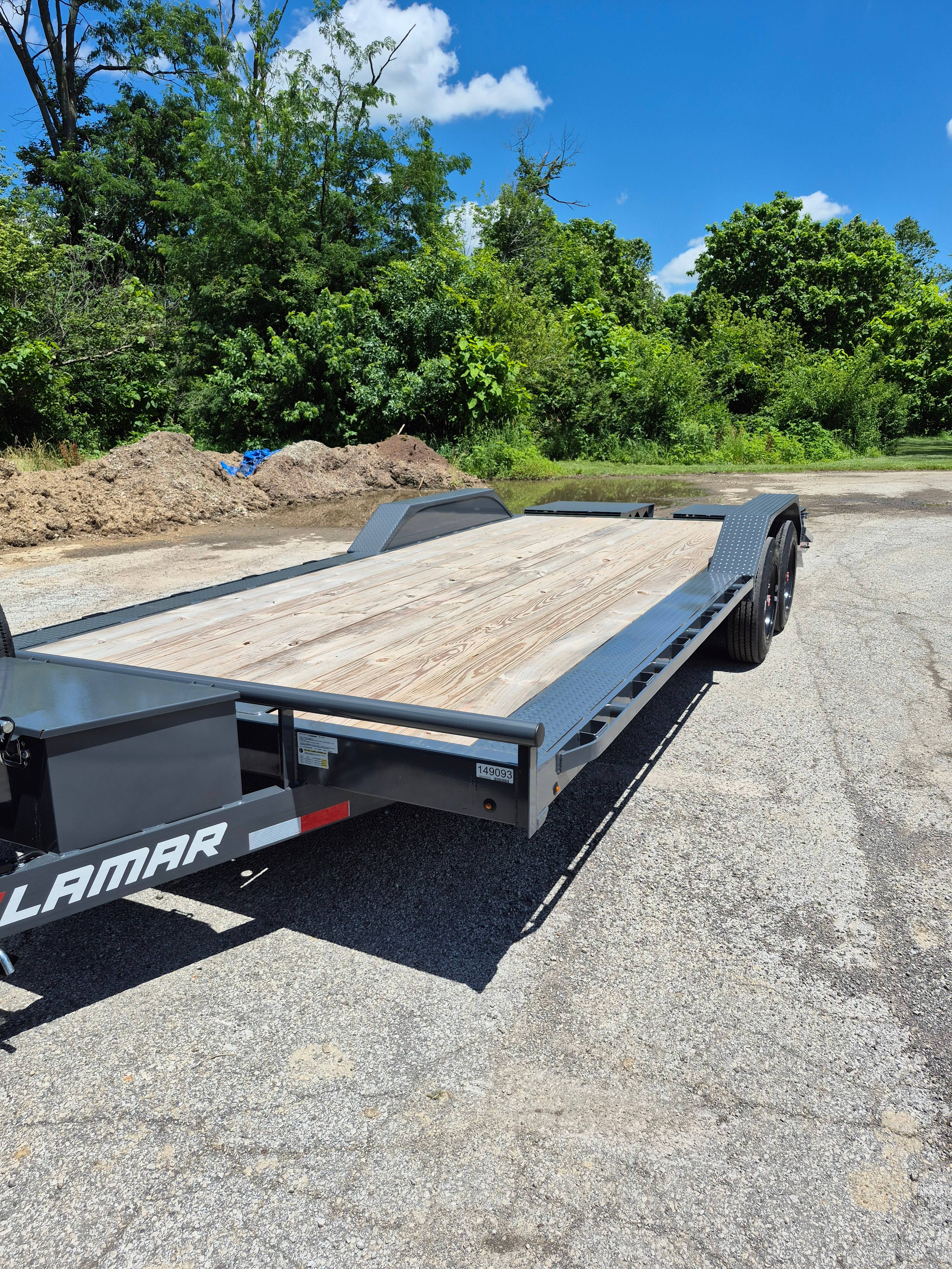 Lamar 22ft equipment trailer side profile showing wood deck and aluminum fenders in Greenfield, IN
