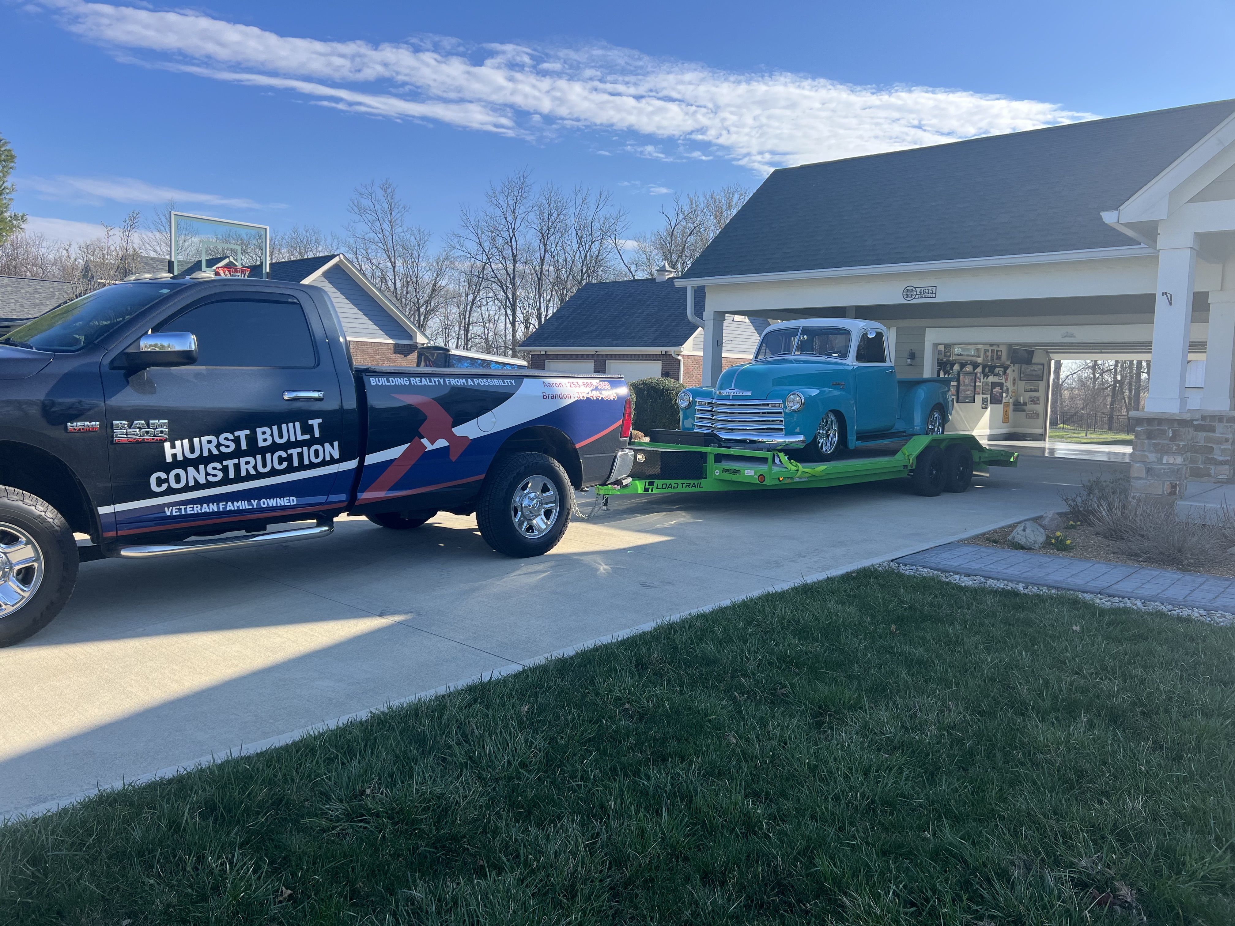 Restored turquoise Chevrolet 3150 pickup truck on flatbed car hauler trailer rental in residential driveway, Greenfield, IN
