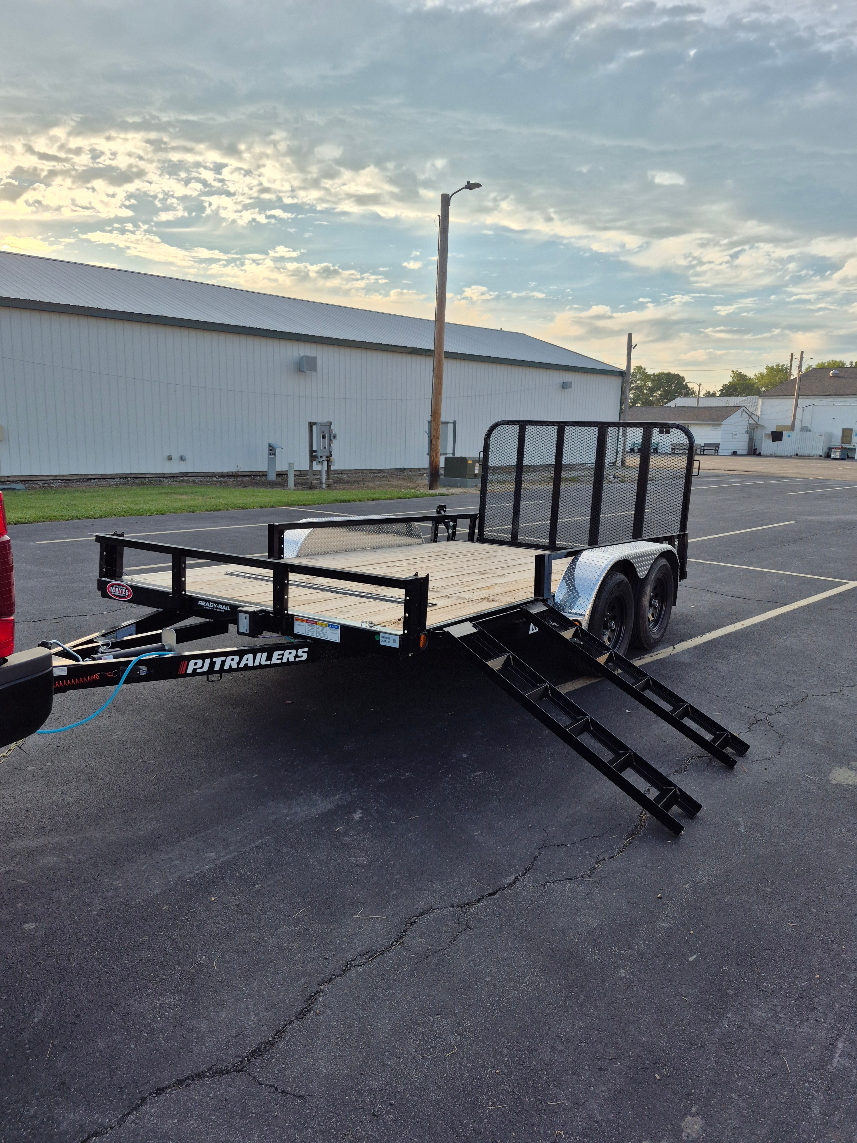 2026 PJ Trailers 14x83in utility trailer full side profile showing wood deck and side loading ramps in Greenfield, IN